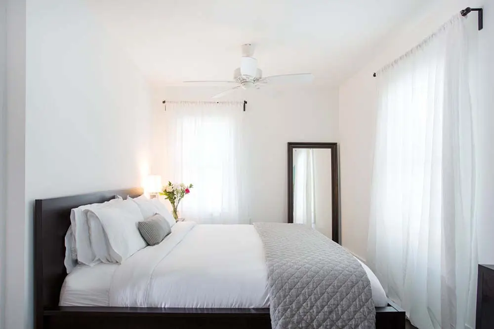 bed with mirror and large windows