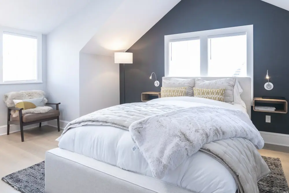 Large bed is flanked by in-wall nightstands.