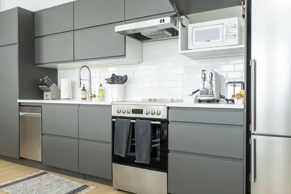 Kitchen with stove-top, oven, microwave and sink.